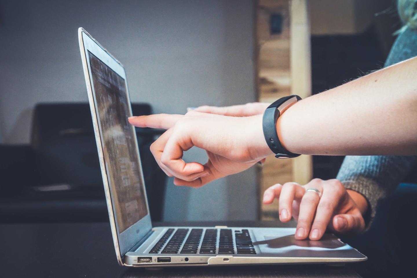 lap top finger pointing to screen