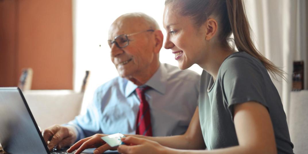 young woman old man computer