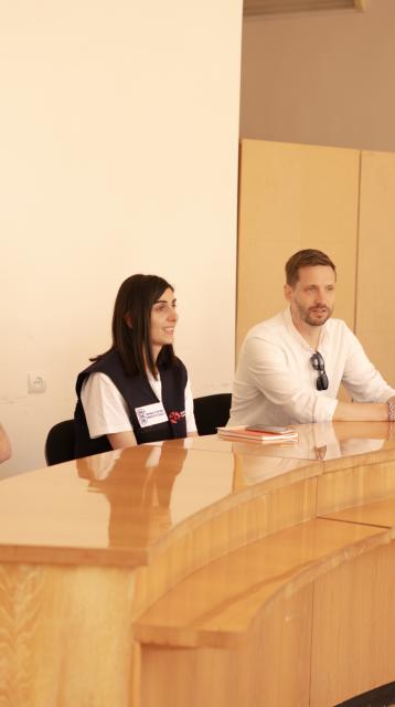 People sitting at a table discussing 